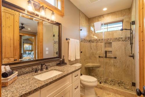 a bathroom with a toilet and a sink and a shower at Valley View in Banner Elk