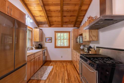 a kitchen with wooden cabinets and a stove top oven at Knotty Pine in West Jefferson