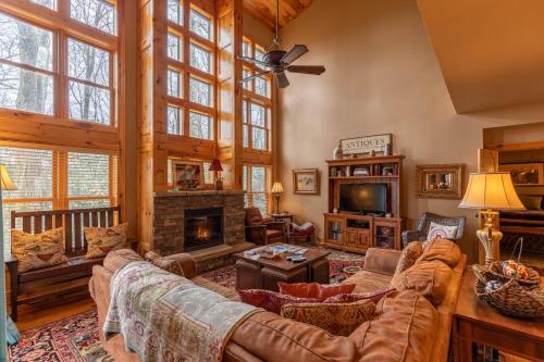 a living room with a couch and a fireplace at Mossy Path Hideaway in Blowing Rock