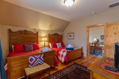 a bedroom with two beds and a mirror at Mossy Path Hideaway in Blowing Rock