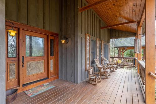 a porch of a house with rocking chairs on it at Mossy Path Hideaway in Blowing Rock