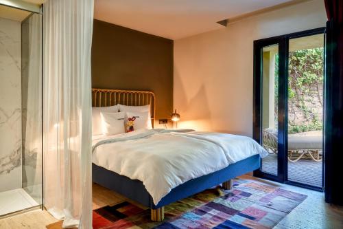 a bedroom with a large bed and a window at Bikini Island & Mountain Port de Soller "Adults only" in Port de Soller