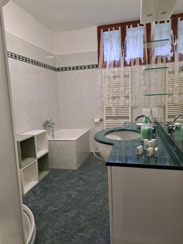 a bathroom with a sink and a toilet and a tub at Casa di Gian in Levanto