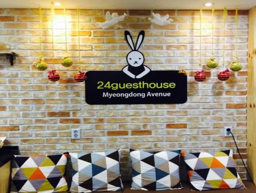 a sign on a brick wall with a bunny on it at 24 Guesthouse Myeongdong Avenue in Seoul