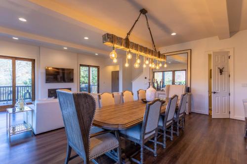a dining room and living room with a table and chairs at Maynard Rocks IV at Elk Creek in Banner Elk