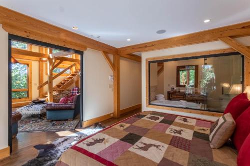 a bedroom with a large window and a living room at Rustic Cedar Rock Townhome at Eagles Nest in Banner Elk