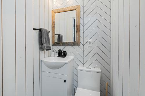 a bathroom with a sink and a mirror and a toilet at Modern Gatsby 2b15b Caldwell Near Golf Course! in Caldwell