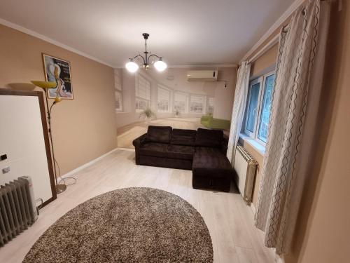 een woonkamer met een bank en een tapijt bij Aviatiei Apartments near Caramfil street in Boekarest