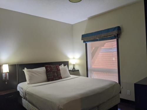 a bedroom with a large bed and a window at The Grotto in Canmore