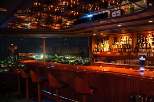 a bar with a view of a city at Okinawa Grand Mer Resort in Okinawa City