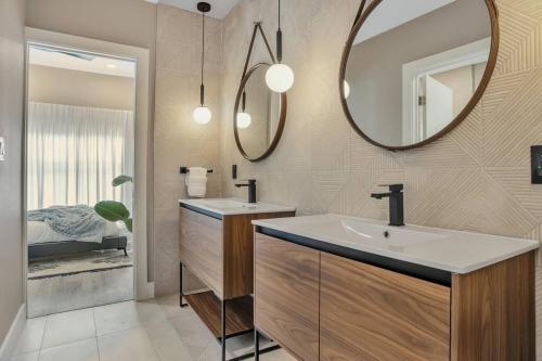 a bathroom with a sink and a mirror at Stunning 2 Story Villa with Pool in Fort Lauderdale