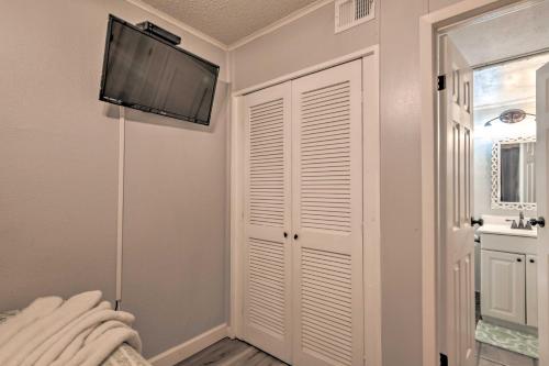 a room with a flat screen tv and a closet at Beachfront Corpus Christi Condo with Arcade Room! in Corpus Christi