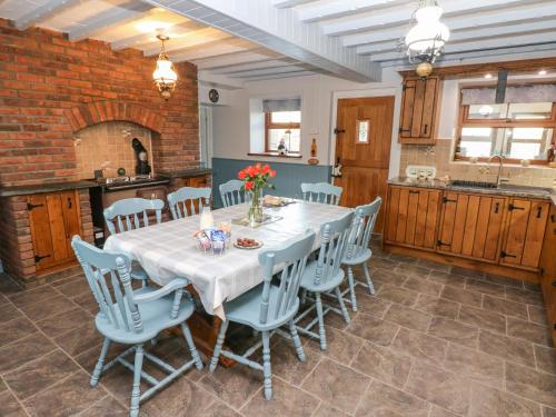 a dining room with a white table and chairs at Pant Teg Farm in Kidwelly