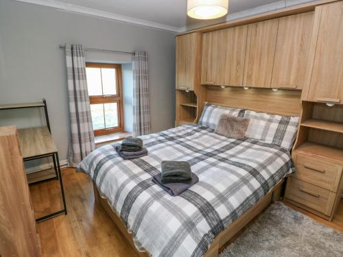 ein Schlafzimmer mit einem Bett mit zwei Hüten darauf in der Unterkunft Pant Teg Farm in Kidwelly