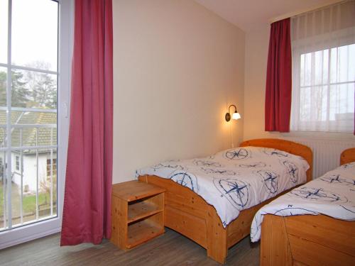 a bedroom with two beds and a window at Resort Orther Reede, Fehmarn-Orth in Orth