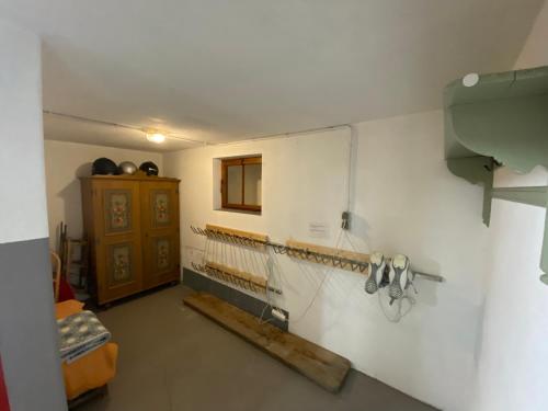 a room with a kitchen with a wall with taps at Gästehaus Schmitt in Lähn