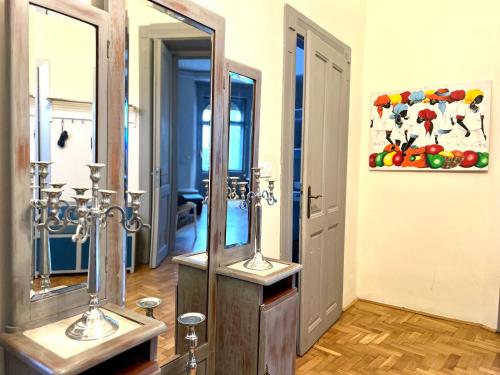 a bathroom with two mirrors in a room at F14 Guest house by Small Home Budapest in Budapest
