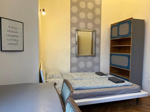 a small room with a bed and a mirror at F14 Guest house by Small Home Budapest in Budapest