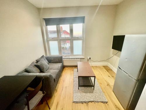 a living room with a couch and a table at Cosy 1 bedroom flat! in London