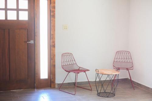 two chairs sitting next to each other in a room at Quinta Monasterio in Valle de Guadalupe