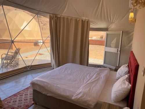 a bedroom with a bed in a tent at Abdullah wadi rum camp in Wadi Rum