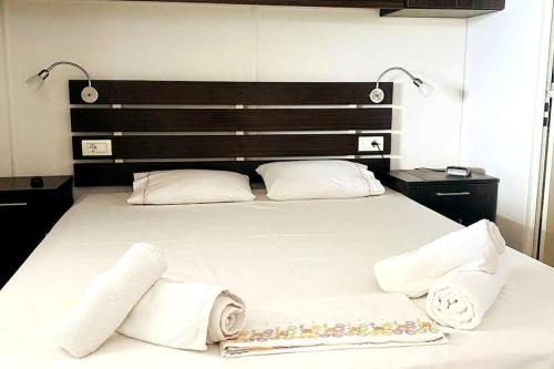 a bedroom with a large bed with towels on it at Belvedere Rare&Peaceful 2BR home+stunning sea view in Tolo