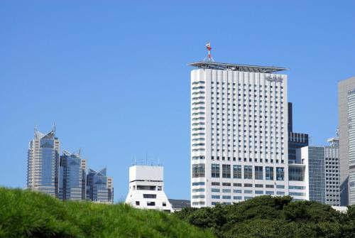 a tall white building with a crane on top of it at Odakyu Hotel Century Southern Tower in Tokyo