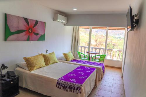 Postel nebo postele na pokoji v ubytování Hotel Bahia Taganga