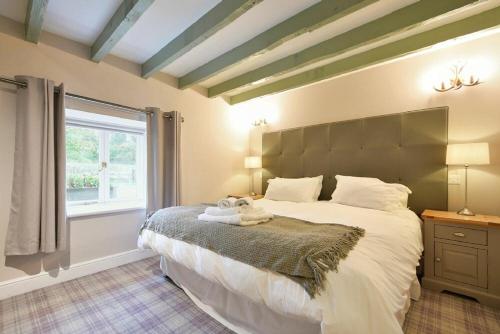 a bedroom with a large bed and a window at Millstone in Lucker