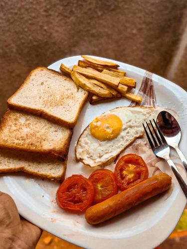 een bord met ontbijtproducten met een ei en toast bij Rofinos Cottages in Parra