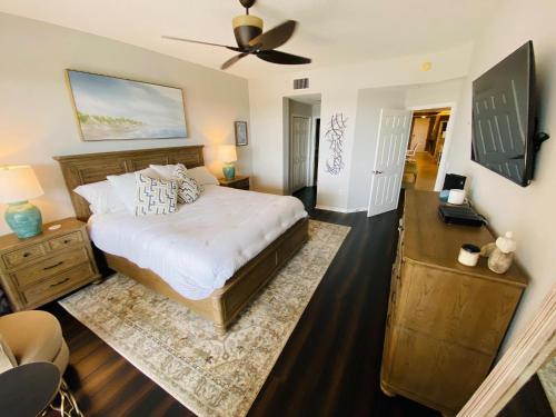 a bedroom with a bed and a ceiling fan at St Pete Beach Penthouse Beach & Intercoastal Views in St Pete Beach