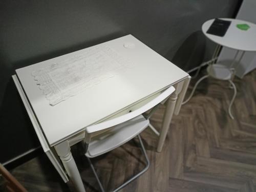 a white desk with a sheet of paper on it at La Torre B&B in Avellino