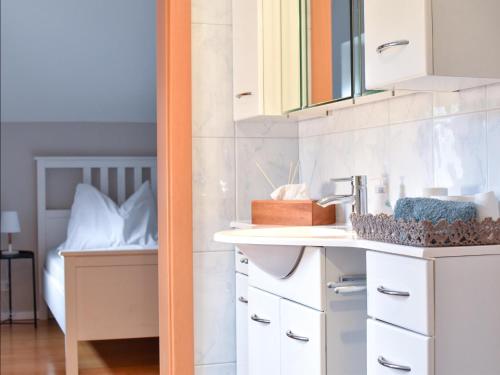 a bathroom with white cabinets and a sink at Ferienwohnung Sattelhof in Türnitz