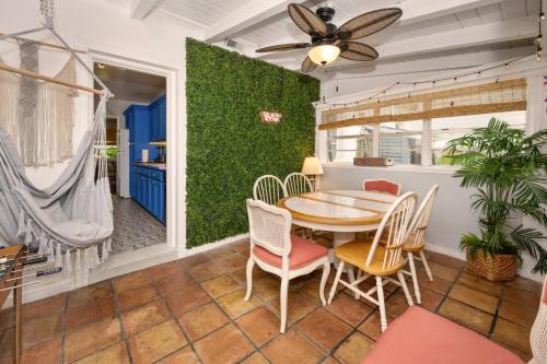a dining room with a table and chairs and a green wall at Cozy Cottage Near Beach in Hollywood