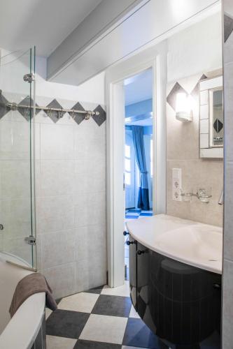 a bathroom with a large tub and a shower at Ferienhaus Strandgut in Oevenum