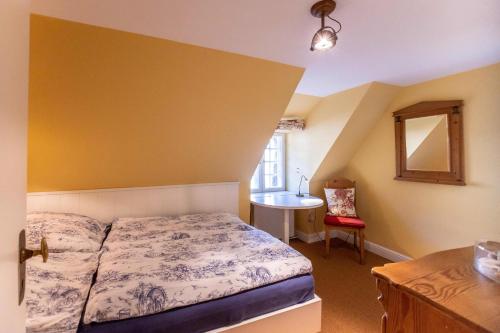 a small bedroom with a bed and a sink at Ferienhaus Strandgut in Oevenum