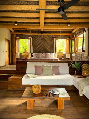 a large bedroom with two beds and a table at Cabaña junto al mar in Zihuatanejo