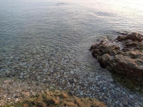 a rocky shore with rocks in the water at La casetta sotto l'albero LA CAROVANA GITANA in Vasto