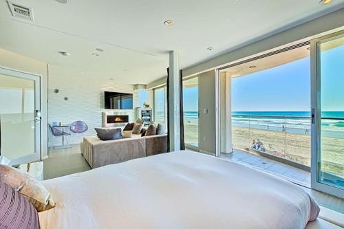a bedroom with a large bed and a view of the beach at Crown Jewel in Mission Beach at Ocean Front Walk in San Diego