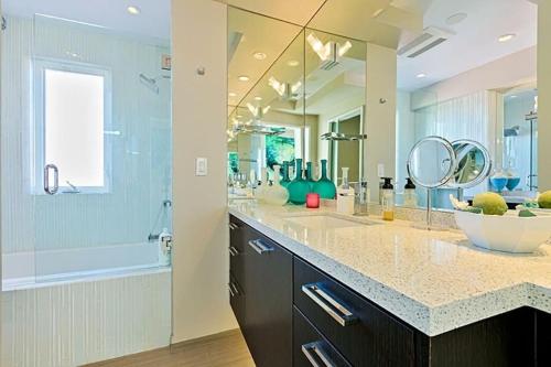 a bathroom with two sinks and a large mirror at Crown Jewel in Mission Beach at Ocean Front Walk in San Diego
