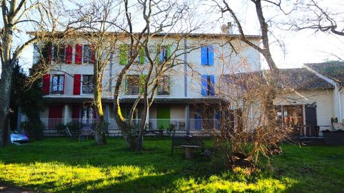 a large house with colorful windows and a yard at Friendly Auberge in Colomiers