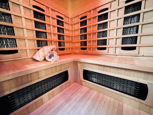a wine cellar with wooden walls and racks of wine bottles at SPA La Casa Blue in Wingles