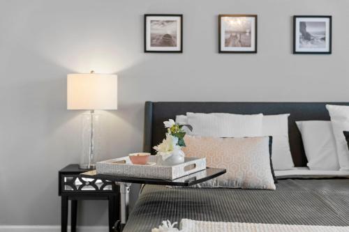a bedroom with a bed and a table with a lamp at Waterfront Luxury 2-Bedroom Condo Sunny Isles Beach in Miami Beach