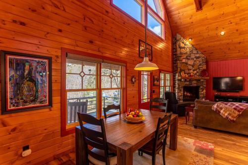 a dining room with a wooden table in a house at A River Mist Walk in Sugar Grove