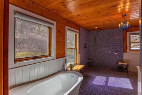 a large bathroom with a tub and a window at A River Mist Walk in Sugar Grove