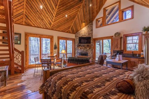 a bedroom with a large bed in a house at River Sound Cabin at Eagles Nest in Banner Elk