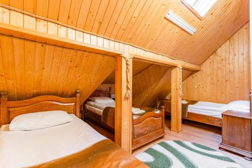 a bedroom with two bunk beds in a attic at Villa Nikoletta SPA in Bukovel
