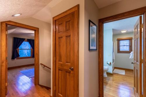 a hallway with a door leading to a bathroom at Nuttin' Better in Blowing Rock