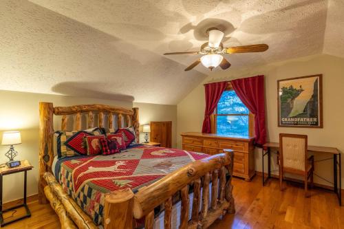 a bedroom with a wooden bed and a ceiling fan at Nuttin' Better in Blowing Rock