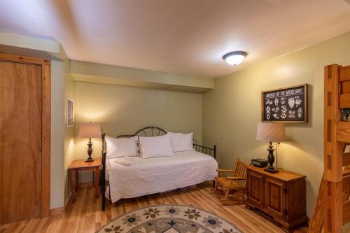 a bedroom with a bed and two lamps and a table at Pine Creek Cabin in Blowing Rock